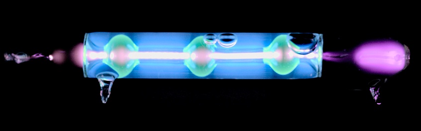 Geissler tube with fluorescent liquid